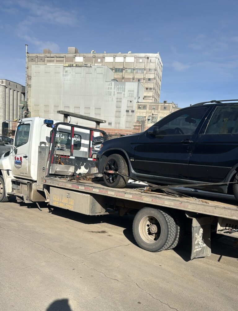 BP Towing flatbed carrying a black car in Calgary