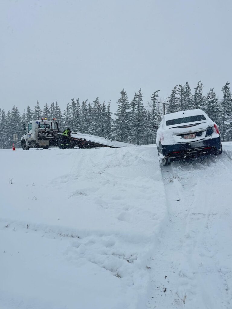 Car stuck in a snowbank awaiting winch out recovery