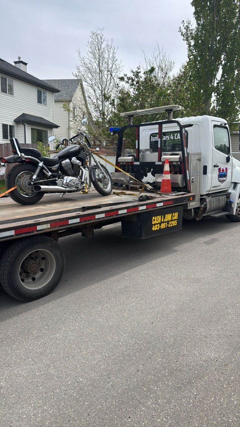 Motorcycle strapped to a BP Towing flatbed in a Calgary neighbourhood