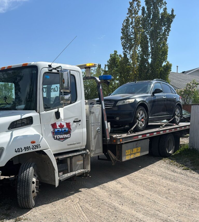 BP Towing flatbed carrying a dark SUV in Calgary